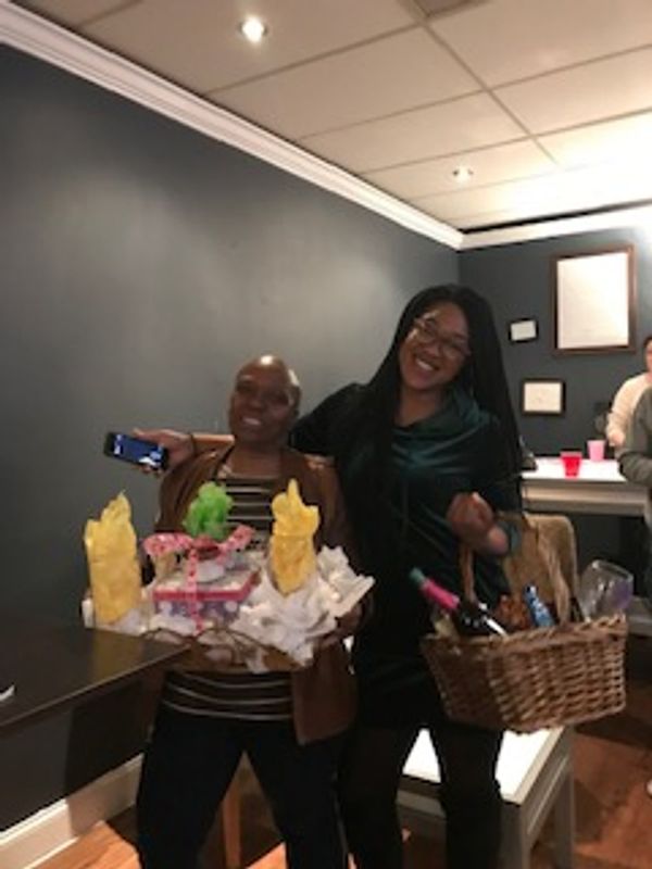 Two guests holding gift baskets