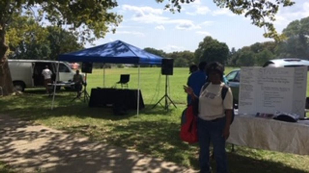 A community day tent and speakers in the park