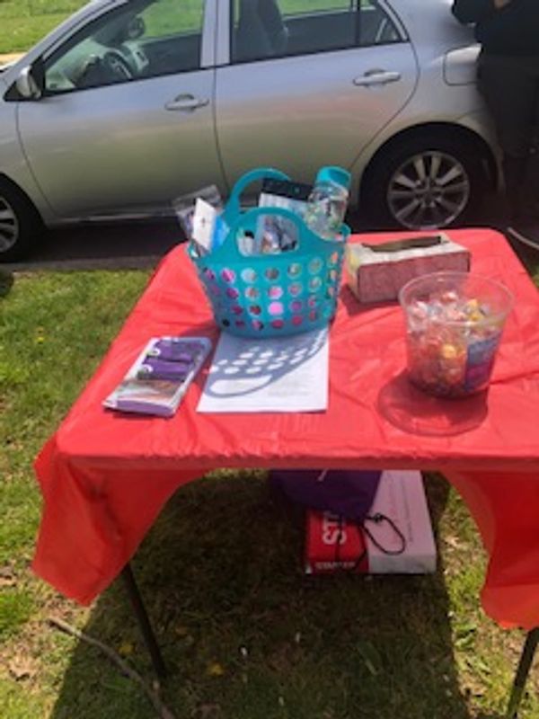 An outreach table with gift baskets
