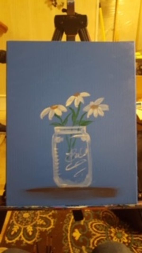 A mason jar daisy painting