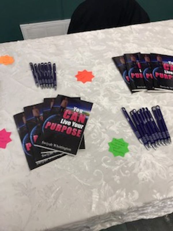 Live Your Purpose flyers and pens on an outreach table